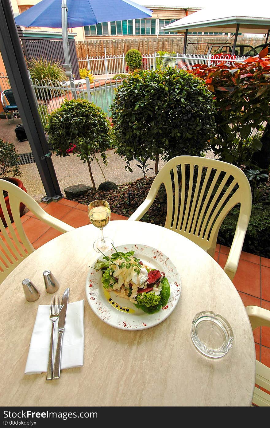 Enjoying a meal with wine and taking in the beautiful landscaping,pool and warm sunny weather. Enjoying a meal with wine and taking in the beautiful landscaping,pool and warm sunny weather