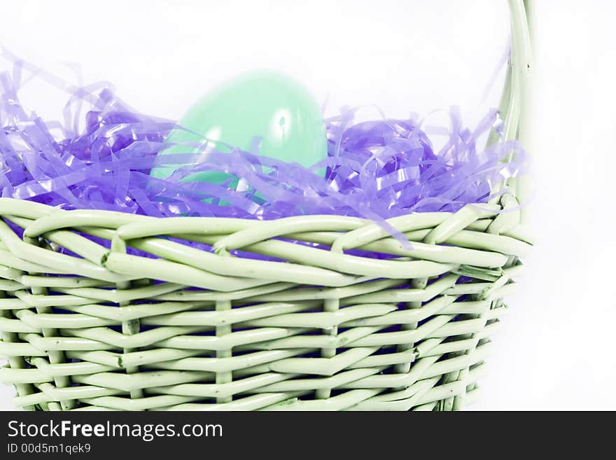 Chocolate easter candy hidden amongst purple hay in basket. Chocolate easter candy hidden amongst purple hay in basket