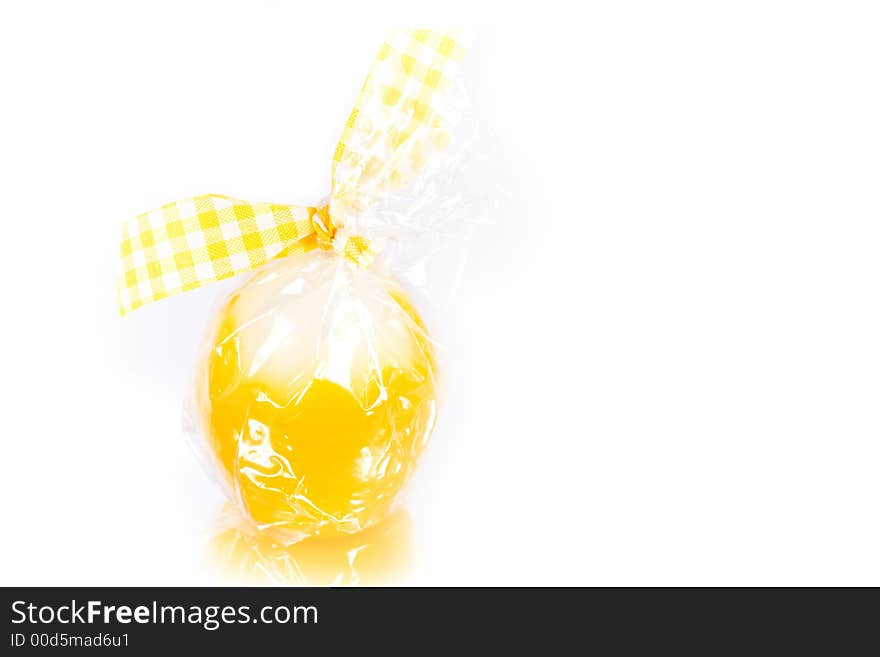 Pretty easter candle reflected on white background