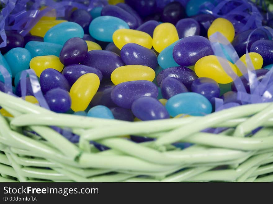 Chocolate easter candy hidden amongst purple hay in basket. Chocolate easter candy hidden amongst purple hay in basket