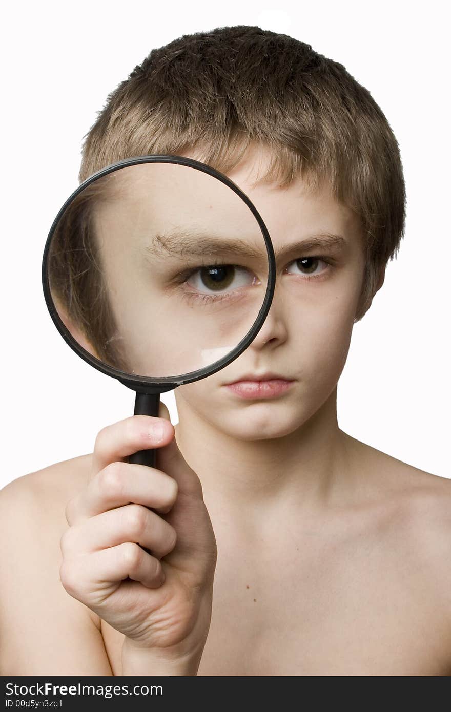 Boy looking through the lens on neutral background