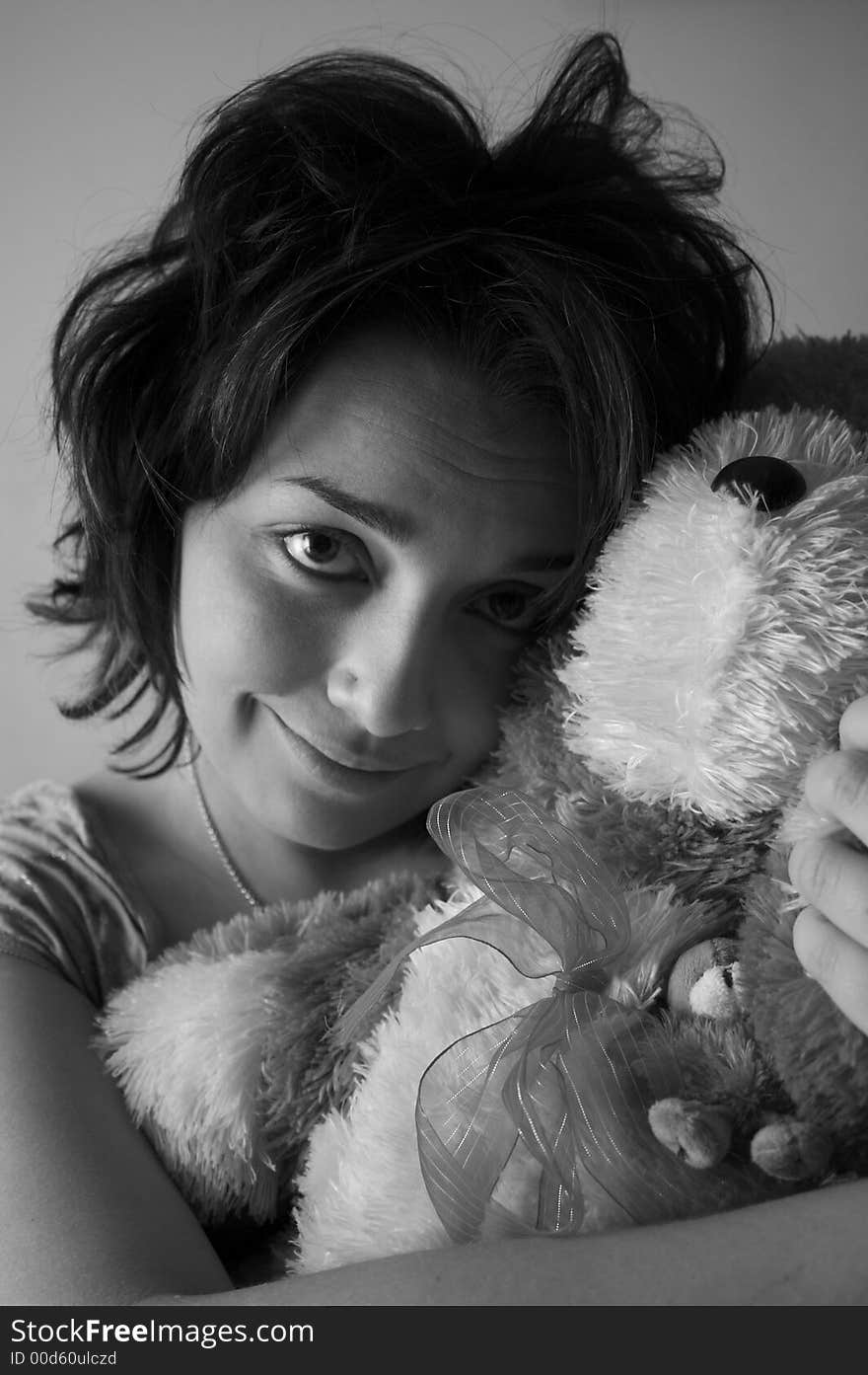 Young brunete girl with her toy bear. Young brunete girl with her toy bear