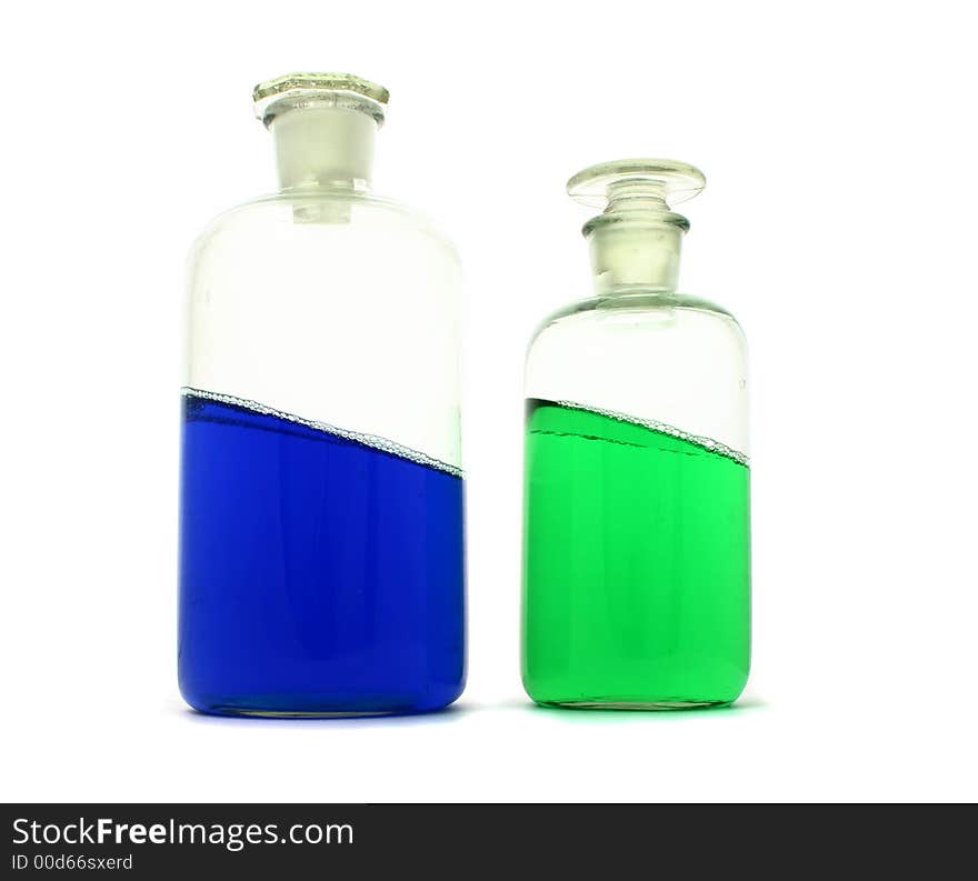 Laboratory bottles with tilted colourful liquid