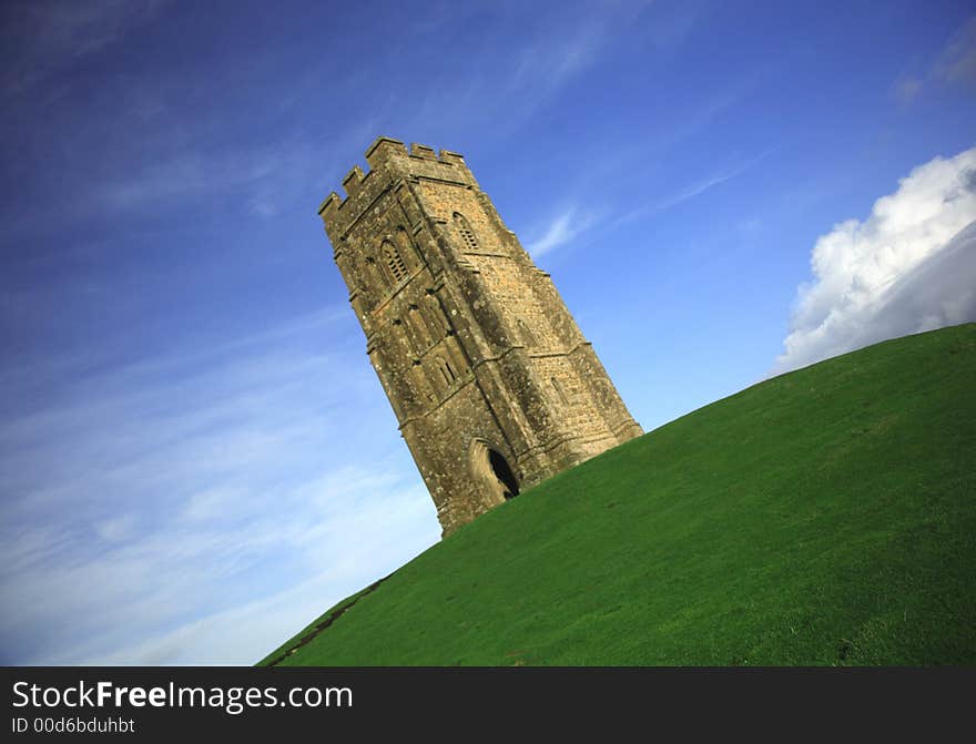 Quirky angle of Glastonbury Tor against a blue sky