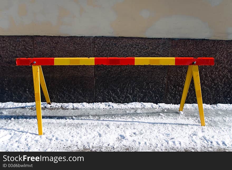 Red and yellow beam on a street in winter. Red and yellow beam on a street in winter