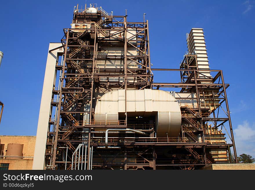 Oil-fired electrical generation facility underneath a perfect blue sky. Oil-fired electrical generation facility underneath a perfect blue sky.