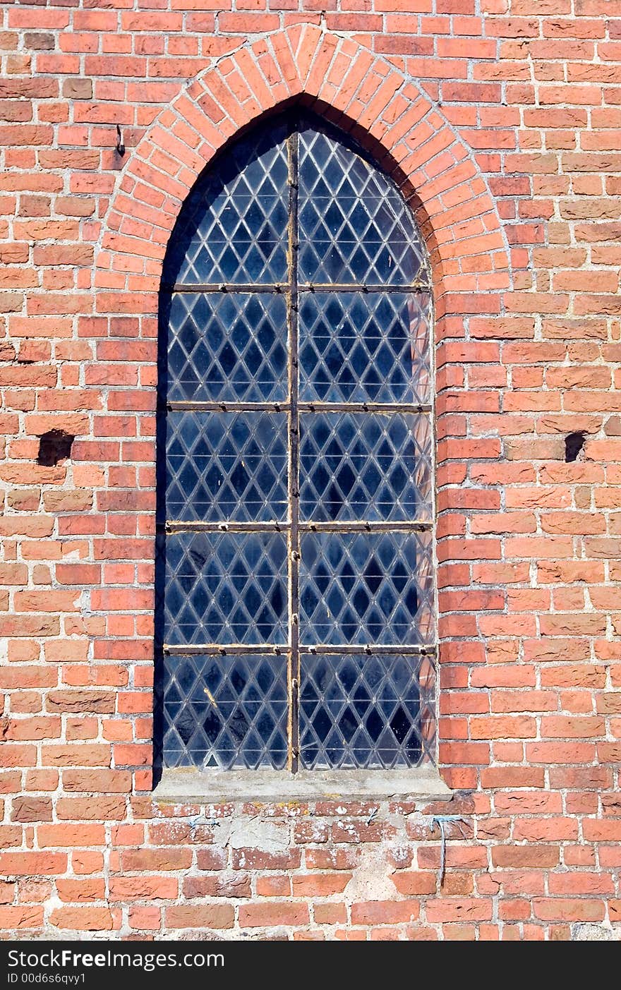 A window in a Polish church. Arch shape. Brick wall, gothic style. MORE PHOTOS OF POLAND Â». A window in a Polish church. Arch shape. Brick wall, gothic style. MORE PHOTOS OF POLAND Â»