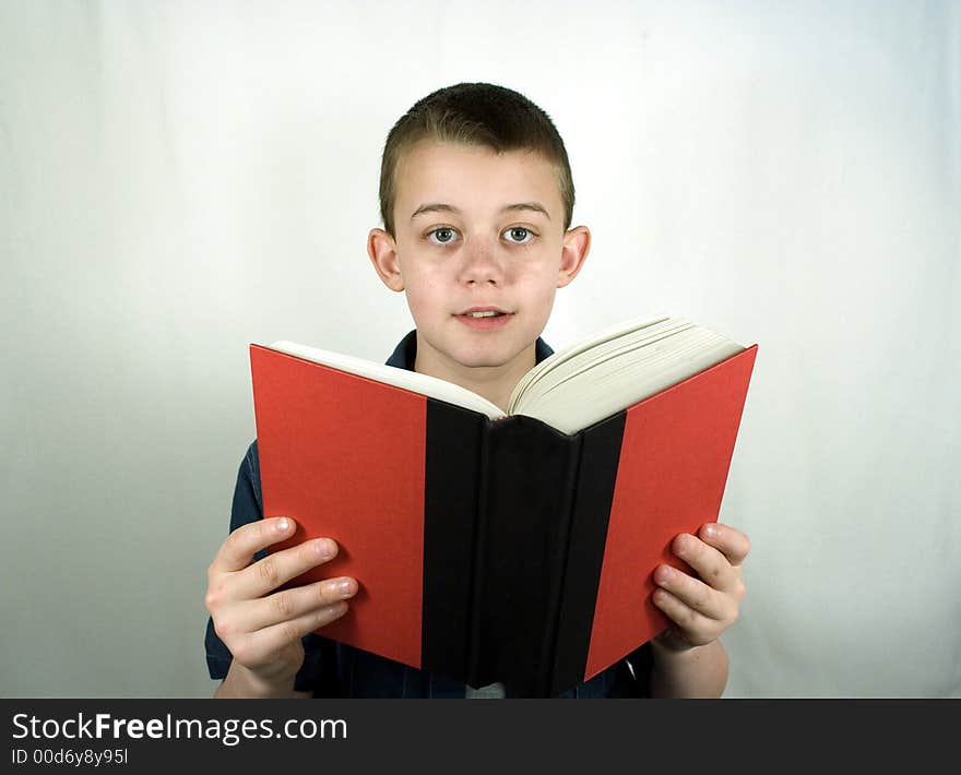 Teen Boy Smiles Reading Book