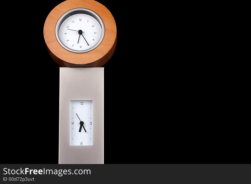 Two clocks stacked on each other against a black background.