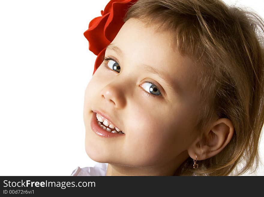 Little smiling girl with red rouses in the hair. Little smiling girl with red rouses in the hair