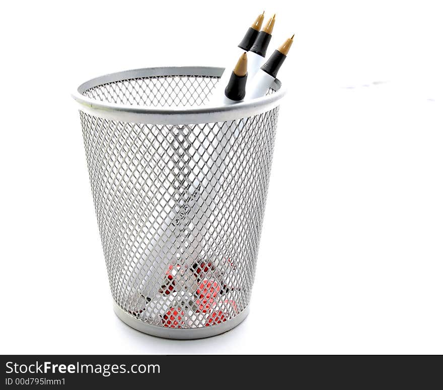 Three pens in a metal holder on a white background. Three pens in a metal holder on a white background