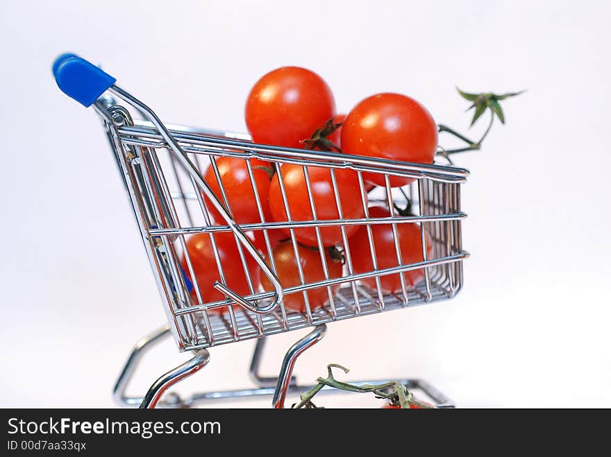 Shopping cart with tomato close up. Shopping cart with tomato close up