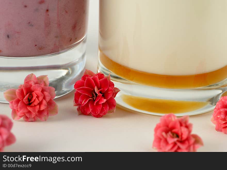 Macro of detail of milk beverage with flowers as deco