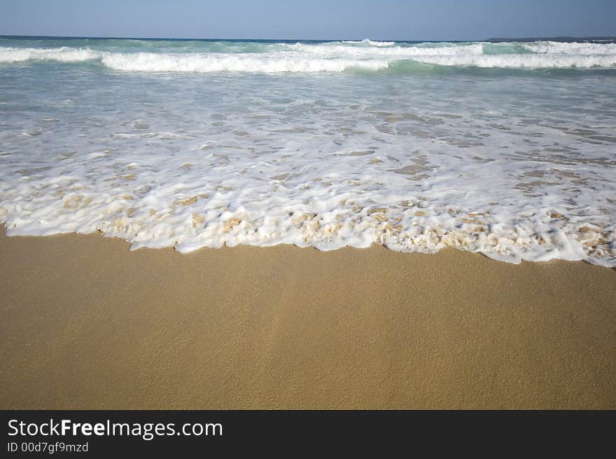 Closeup view of waves crashing on a tropical beach. Closeup view of waves crashing on a tropical beach