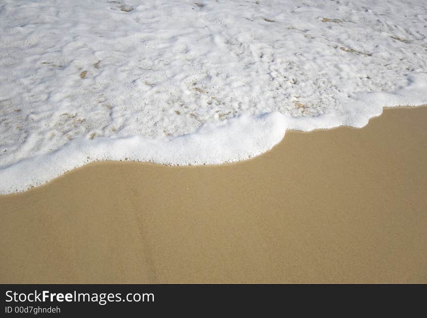 Closeup view of waves crashing on a tropical beach. Closeup view of waves crashing on a tropical beach