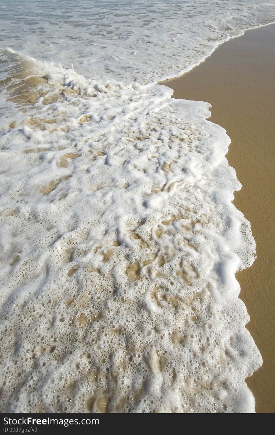 Closeup view of waves crashing on a tropical beach. Closeup view of waves crashing on a tropical beach