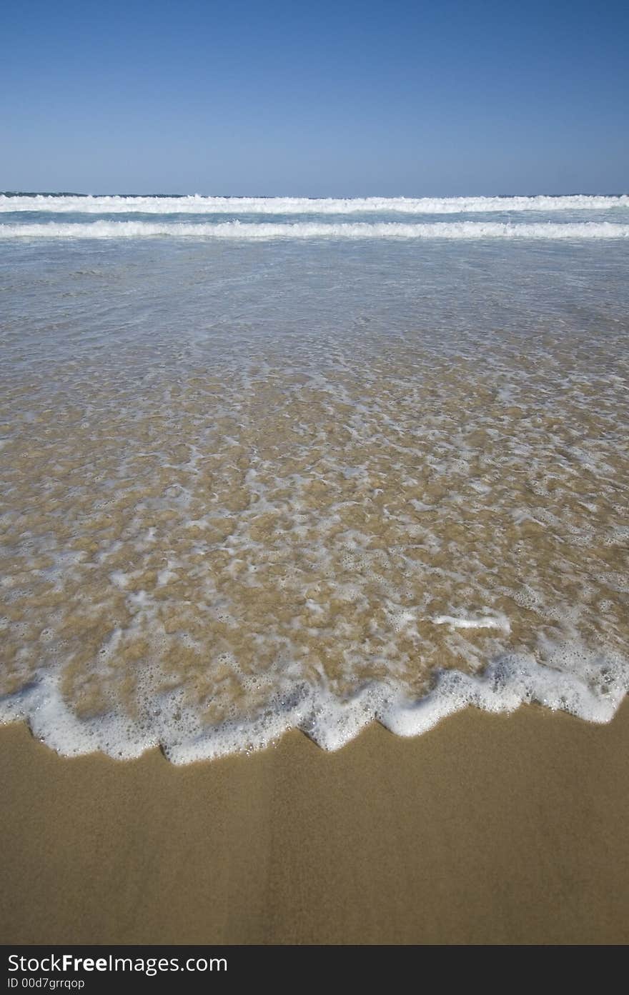 Closeup view of waves crashing on a tropical beach. Closeup view of waves crashing on a tropical beach