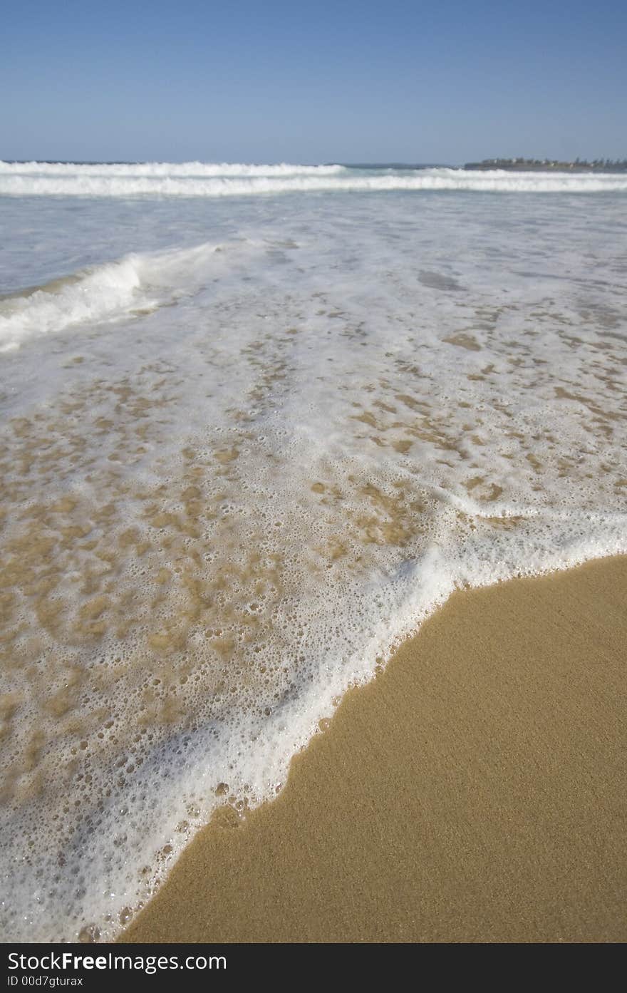 Closeup view of waves crashing on a tropical beach. Closeup view of waves crashing on a tropical beach