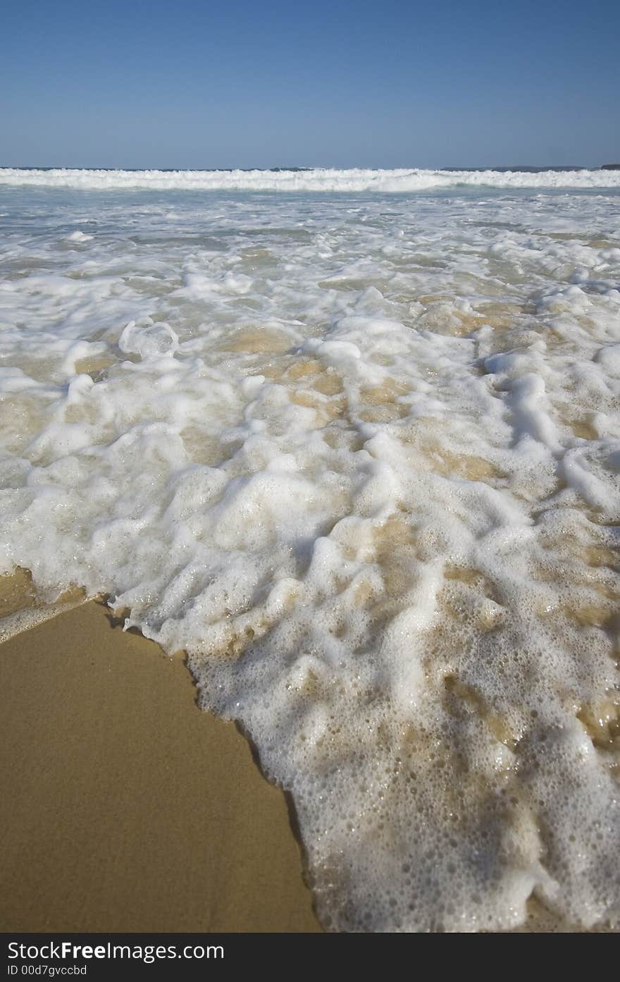 Closeup view of waves crashing on a tropical beach. Closeup view of waves crashing on a tropical beach