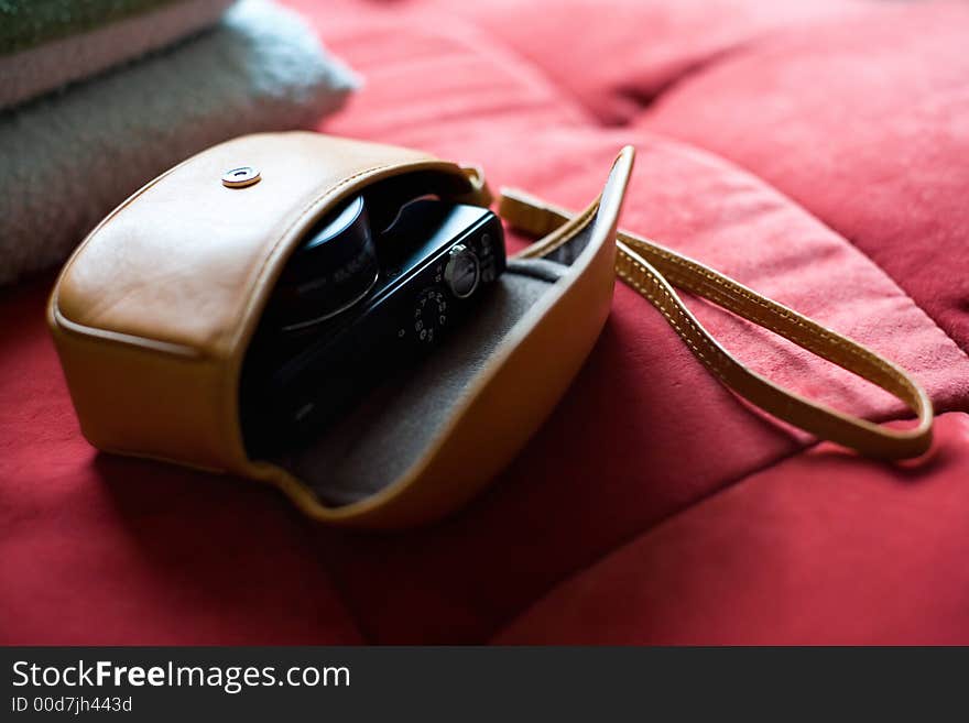 Nice camera on a red sofa.