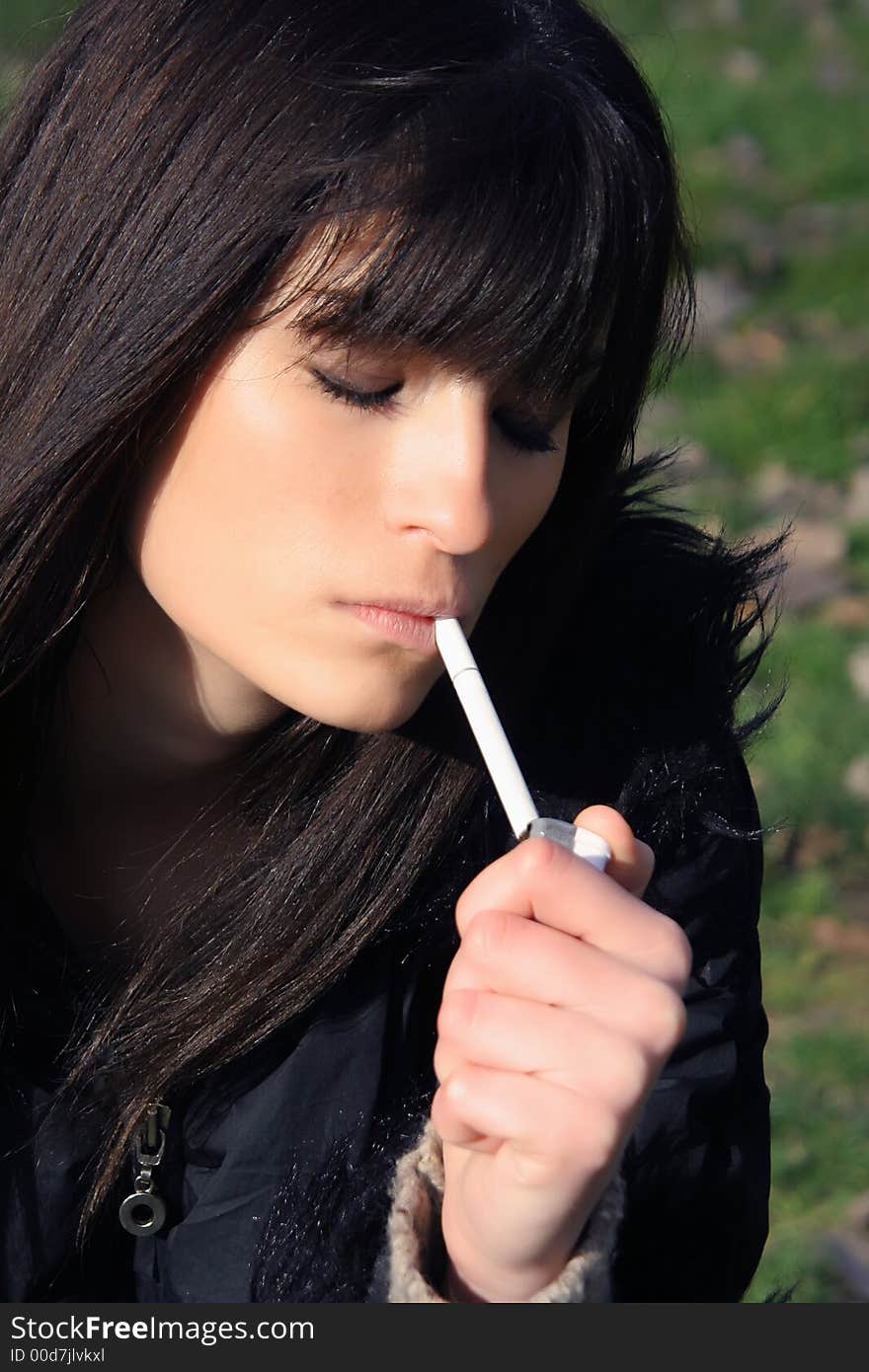 young lady smoke a cigarette. young lady smoke a cigarette