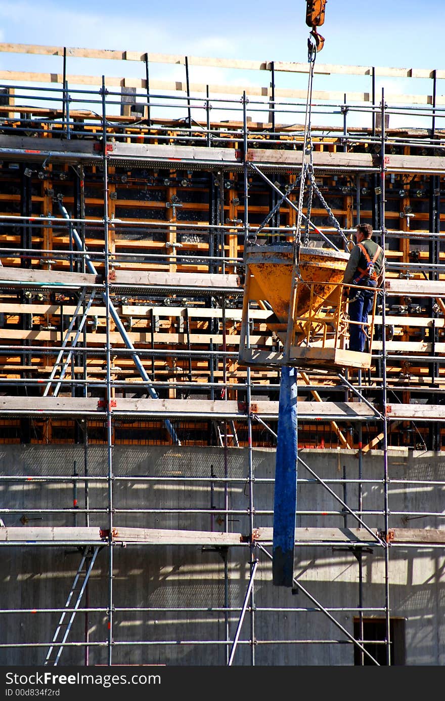 Construction worker in gondola during work. Construction worker in gondola during work