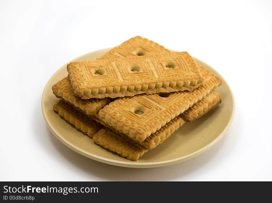 Beautiful cookies in a plate on a white background