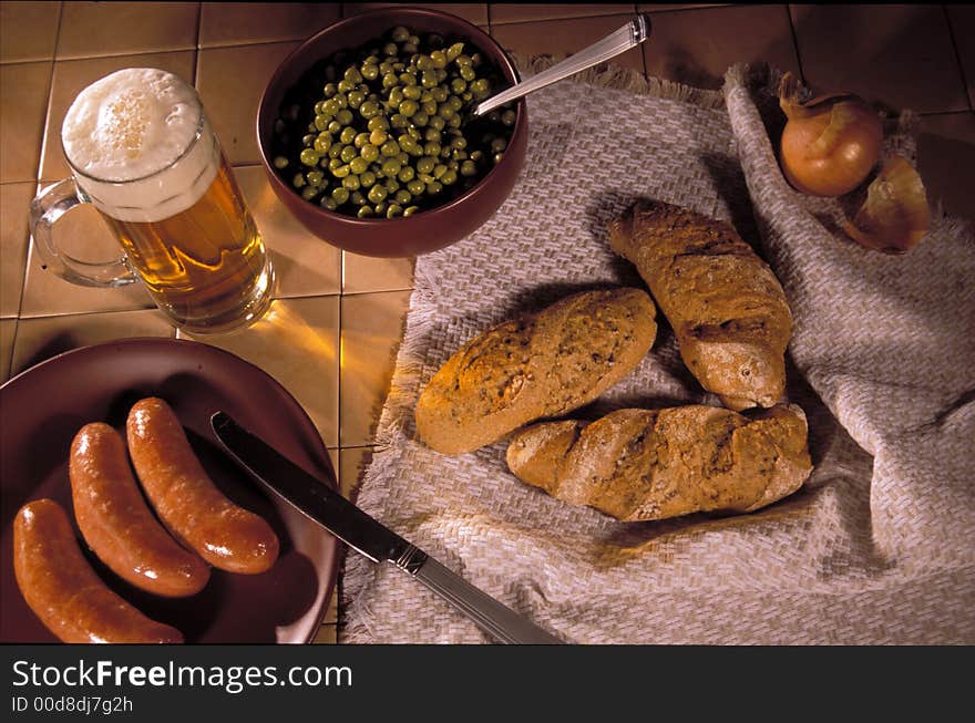 Still-life with a mug of beer, sausages and rolls. Still-life with a mug of beer, sausages and rolls