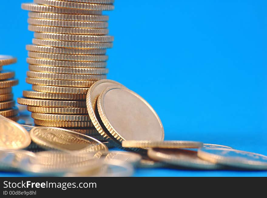 Pile of coins on blue background