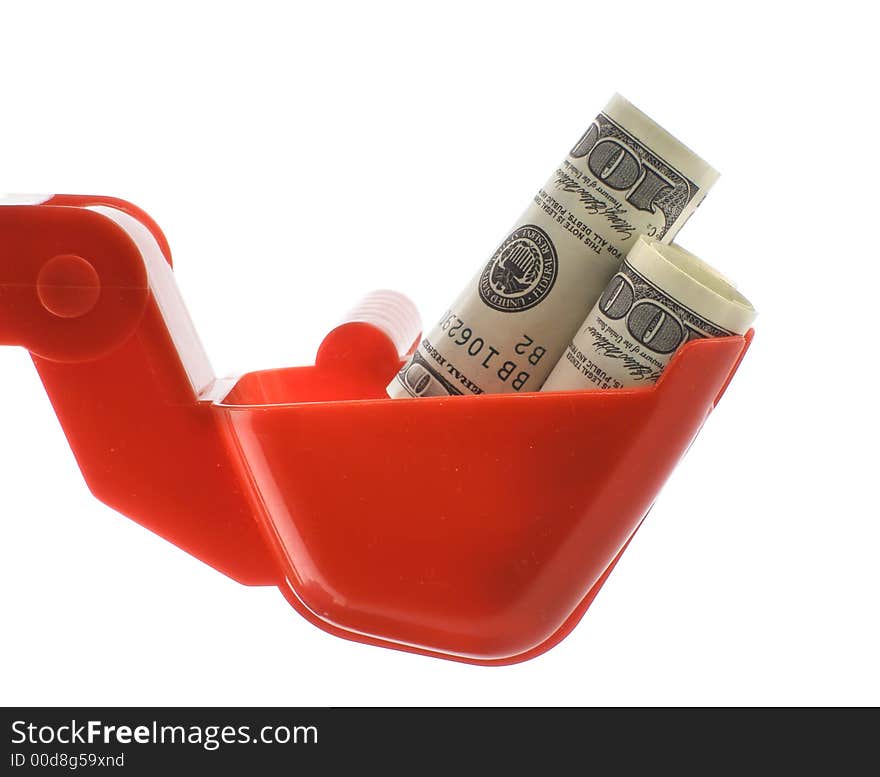 Dollars bills within toy excavator bucket isolated over white background. Dollars bills within toy excavator bucket isolated over white background