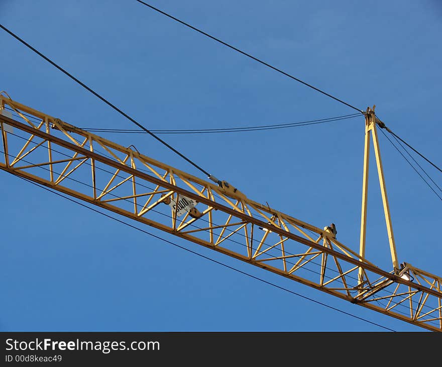 Closeup portrait of yellow crane in blue sky. Closeup portrait of yellow crane in blue sky