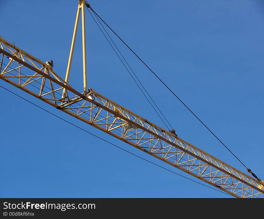 Closeup portrait of yellow crane in blue sky. Closeup portrait of yellow crane in blue sky