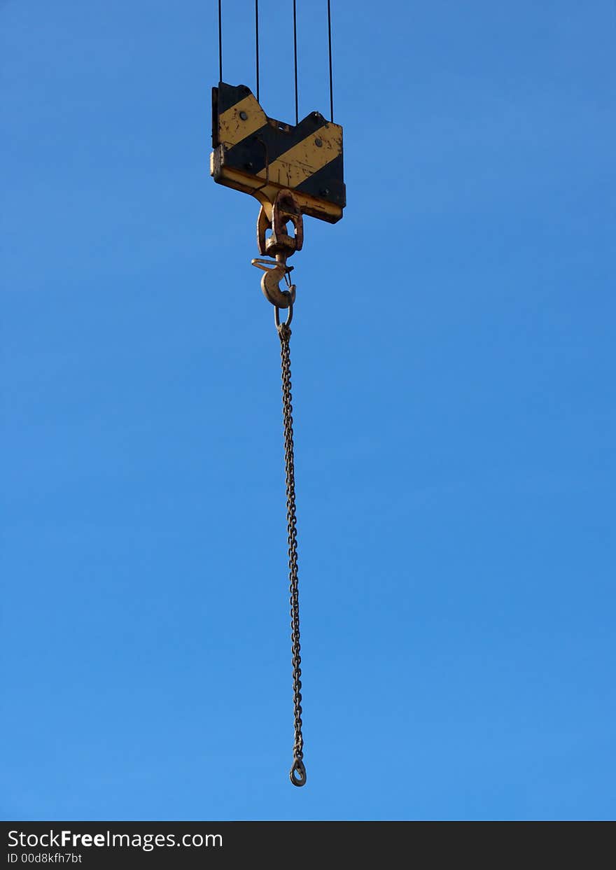 Closeup portrait of yellow crane in blue sky. Closeup portrait of yellow crane in blue sky