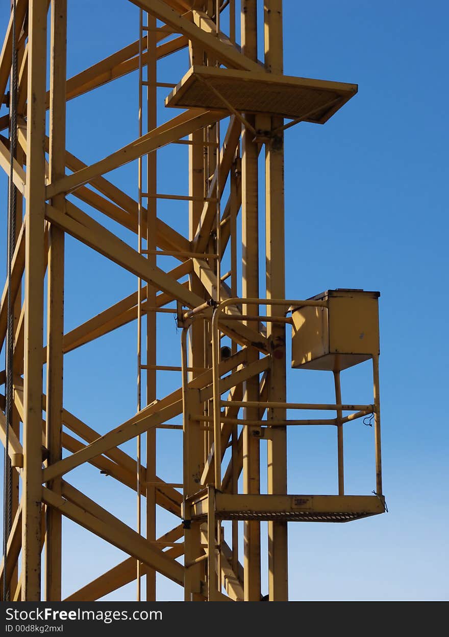 Closeup portrait of yellow crane in blue sky. Closeup portrait of yellow crane in blue sky