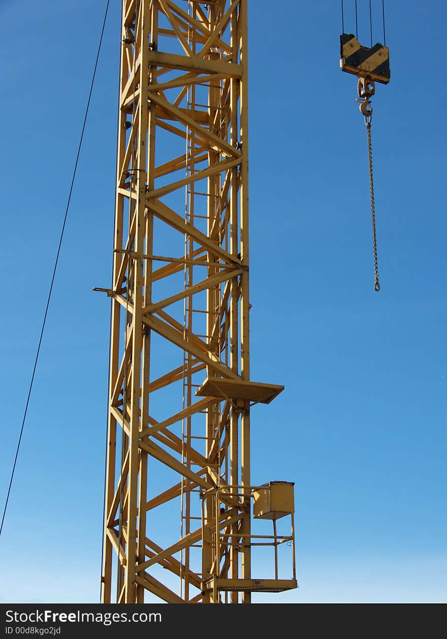 Closeup portrait of yellow crane in blue sky. Closeup portrait of yellow crane in blue sky