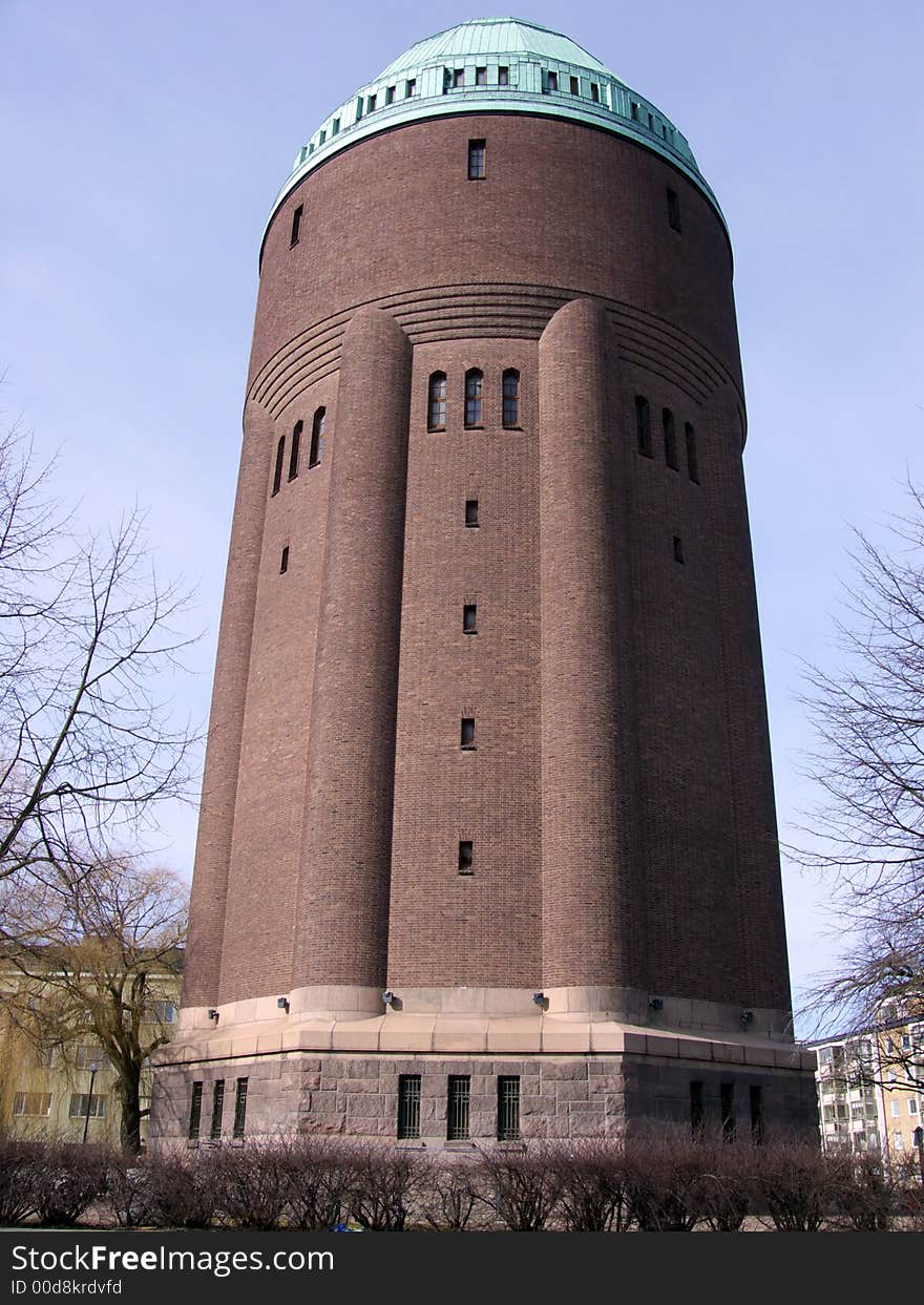 Portrait of huge water tower in blue sky