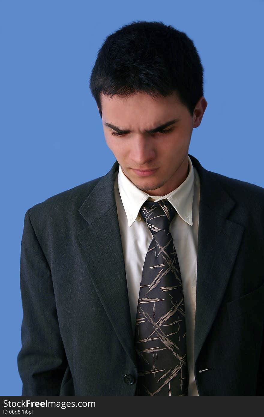 Young businessman angry isolated on blue