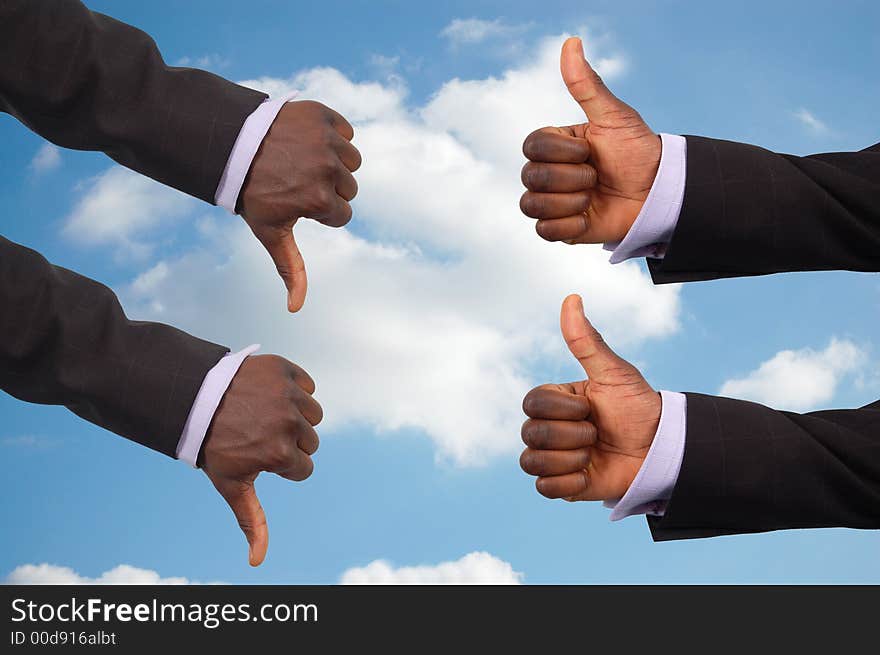 This is an image some hands competing against each other with a sky in the background.This image can be used to represent the theme Team Decisions