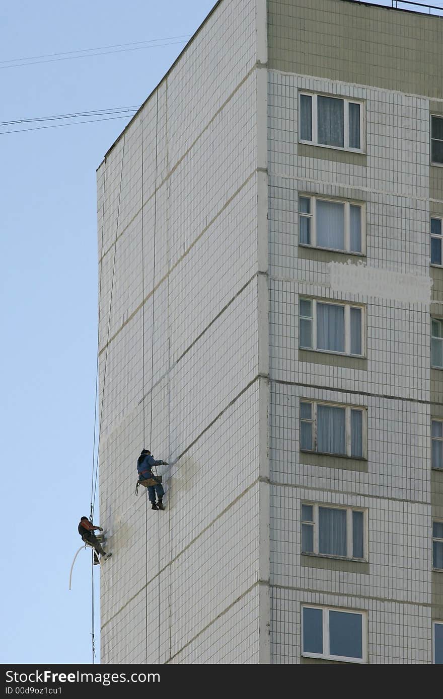 Two men concern with repair of the building