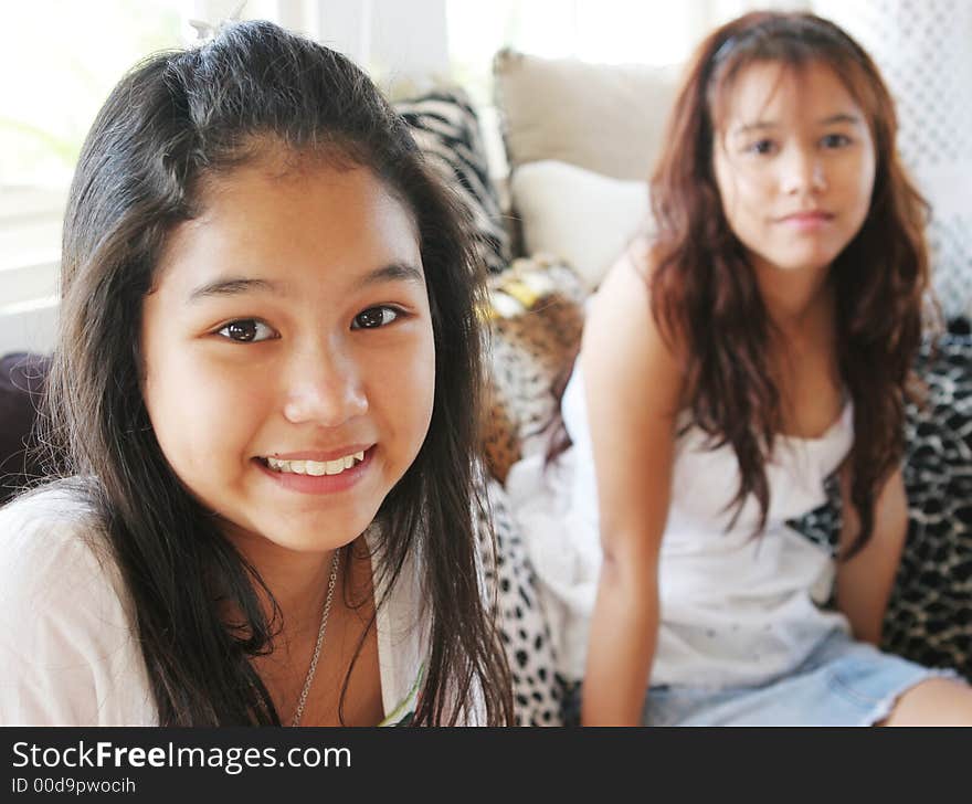 Two happy Thai teenageers at home. Two happy Thai teenageers at home