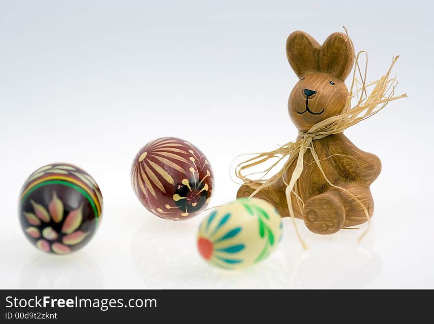 Easter bunny and easter eggs on white background. Low reflection. Easter bunny and easter eggs on white background. Low reflection.