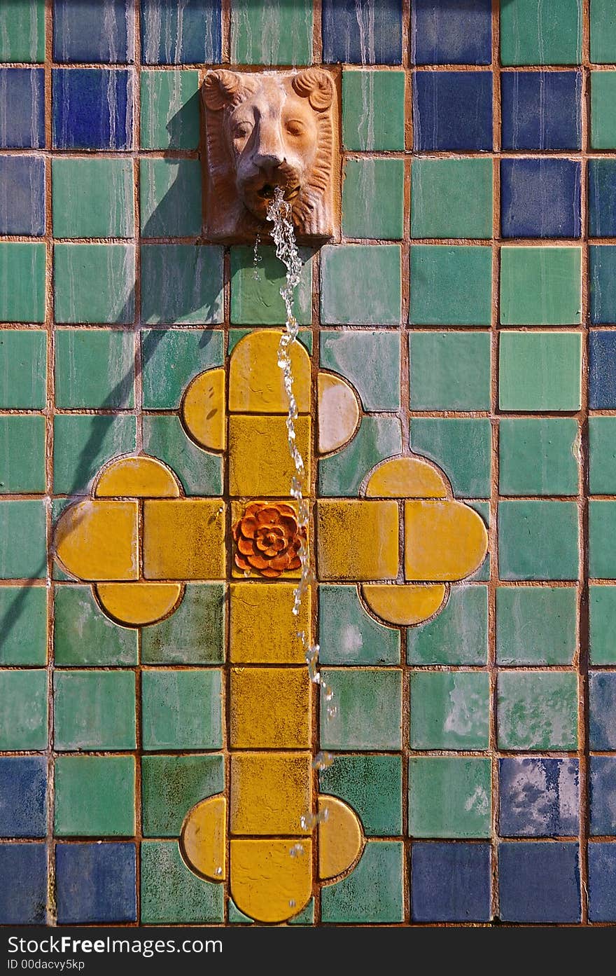 Colorful tile fountain with lion and cross