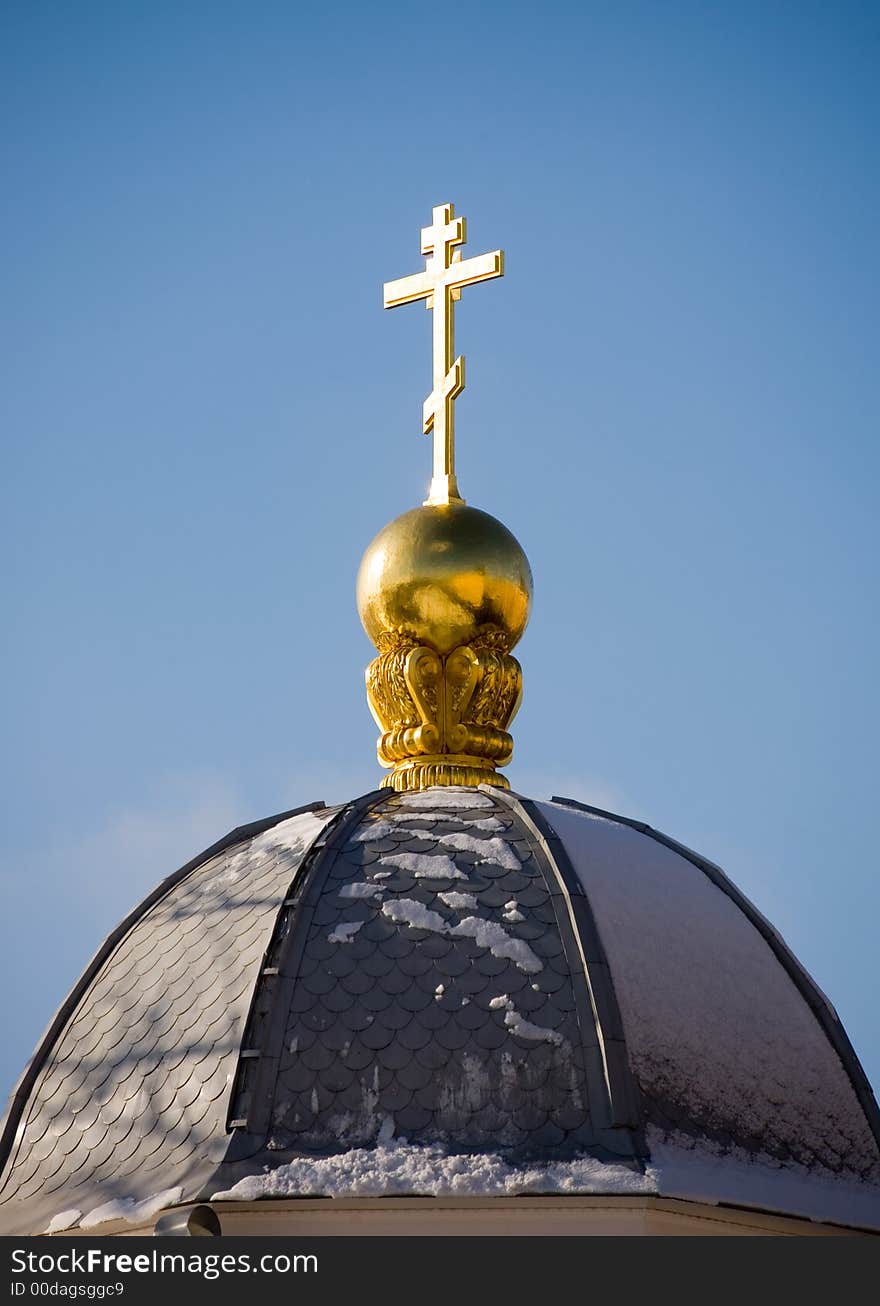 Dome of a chapel and cross on a background of the sky