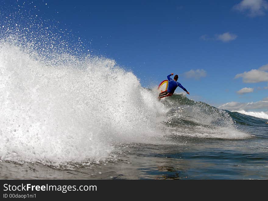 A shortboarder surfing hitting the lip. A shortboarder surfing hitting the lip