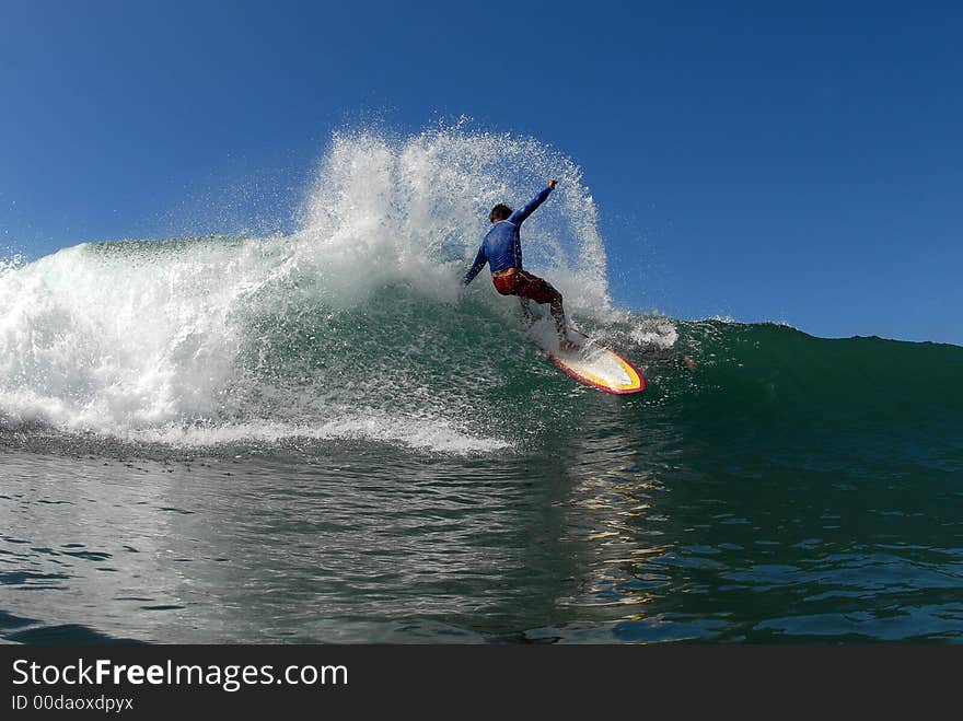 A shortboarder surfing hitting the lip. A shortboarder surfing hitting the lip