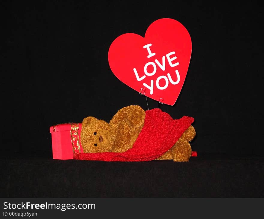 Teddy bear with red cloth across lap and sign of love. Teddy bear with red cloth across lap and sign of love