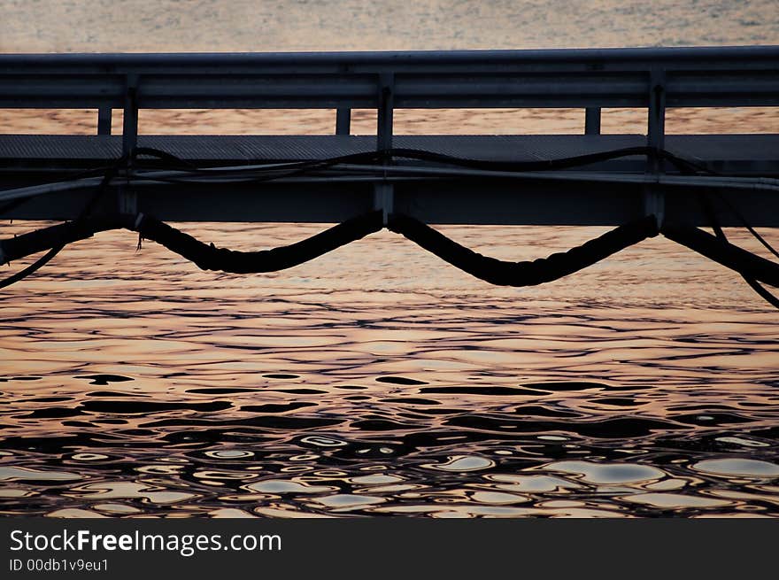 A small bridge with water and sunset. A small bridge with water and sunset