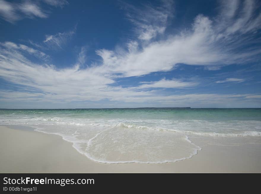 Closeup view of waves crashing on a tropical beach. Closeup view of waves crashing on a tropical beach