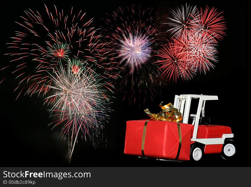 Picture of a forklift toy car bringing a gift with fireworks on the background. From my brothers toy collection. Made in the 1970's. Picture of a forklift toy car bringing a gift with fireworks on the background. From my brothers toy collection. Made in the 1970's