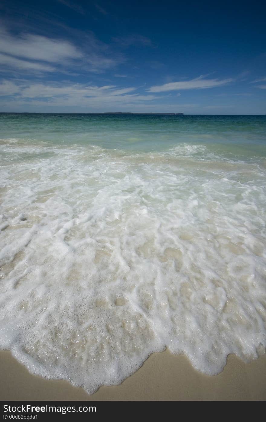 Closeup view of waves crashing on a tropical beach. Closeup view of waves crashing on a tropical beach